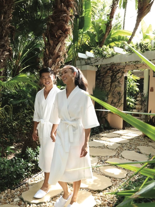 A couple walking in robes in Nassau Paradise Island