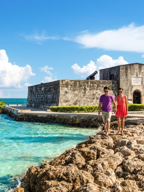 A couple walking near a fort in Nassau Paradise Island