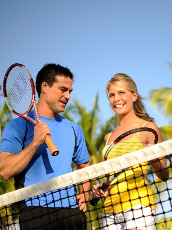 A couple playing tennis at Bay View Suites Paradise Island