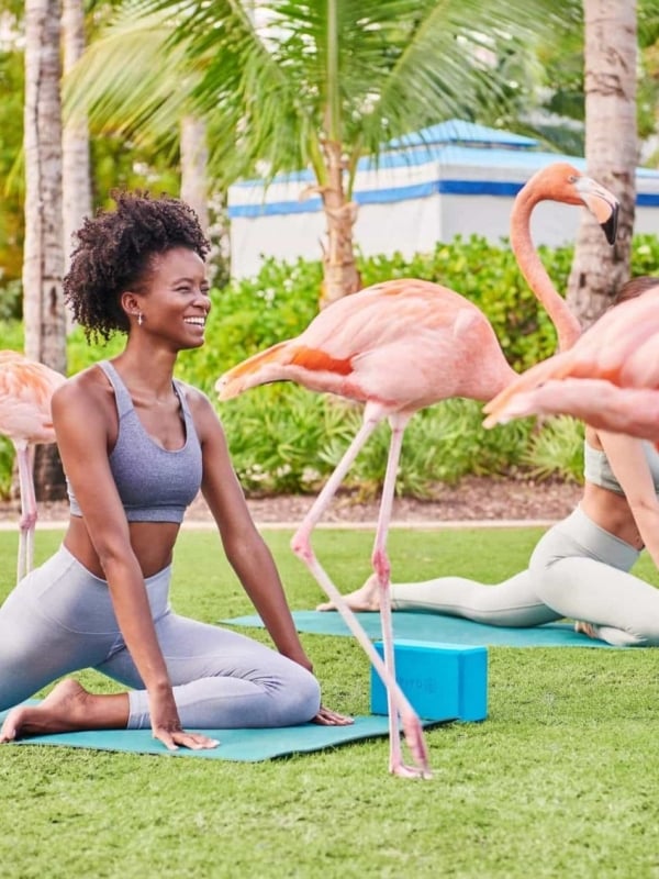 A woman doing flamingo yoga at Baha Mar