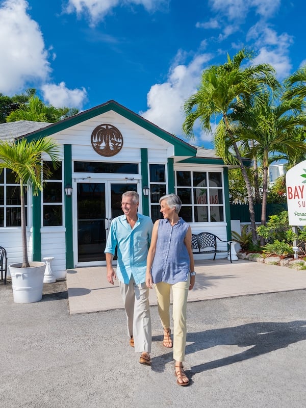 A couple walking out of Bayview Suites Paradise Island, Bahamas