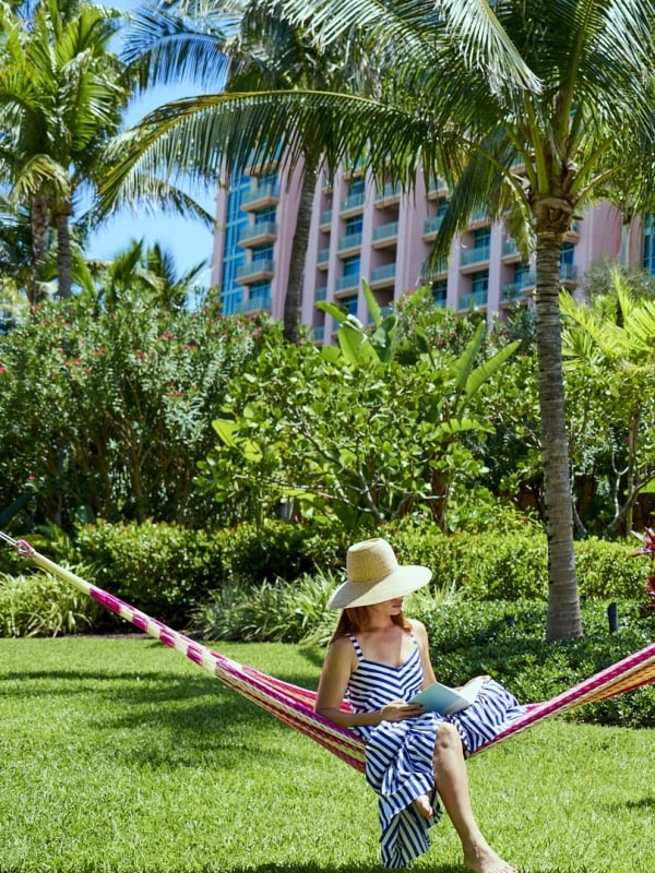 A woman in a hammock outside the Cove at Atlantis Paradise Island