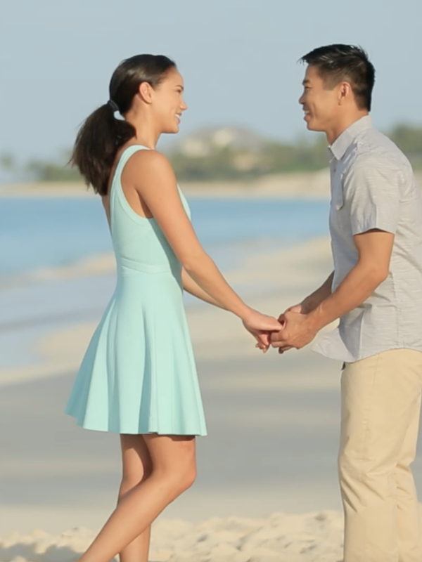 A couple getting engaged on the beach in Nassau Paradise Island