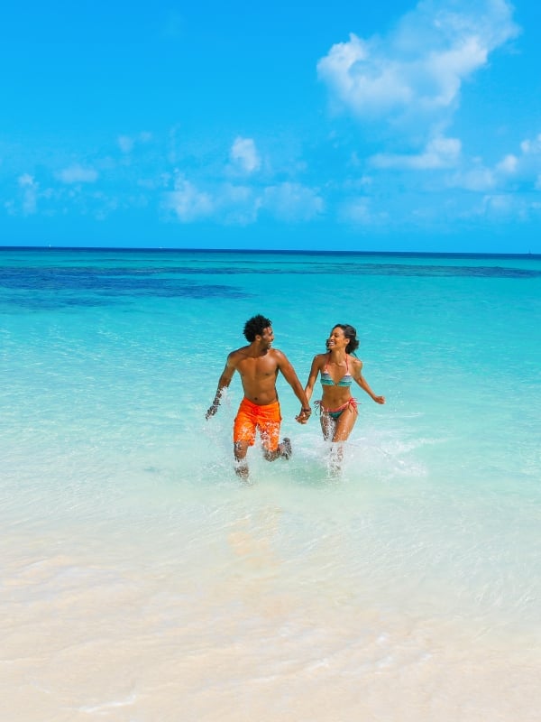 A couple in the water on the beach in Nassau