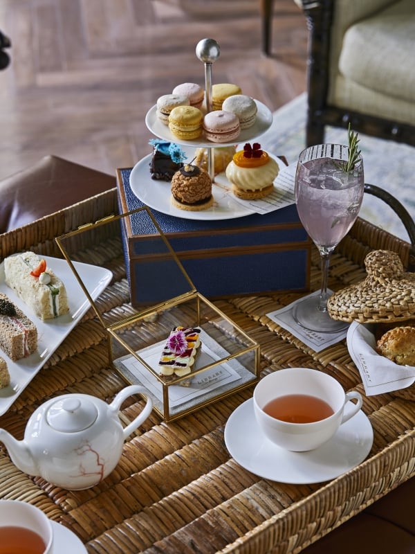 afternoon tea set up on a wicker table