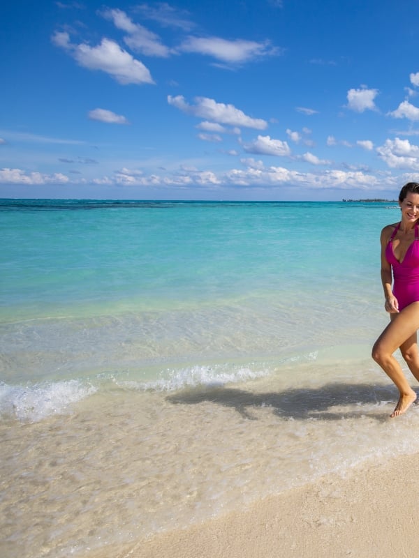 A couple running on the beach in Nassau Paradise Island