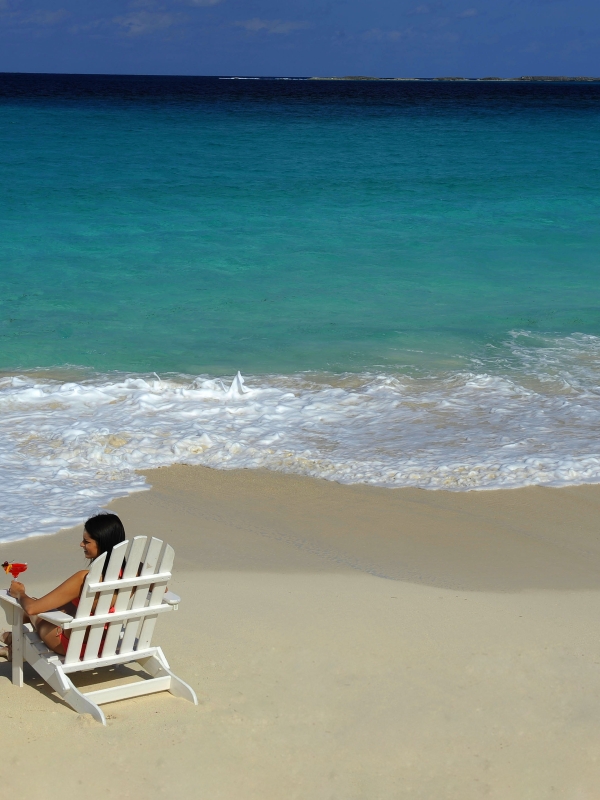 A couple sitting on Cabbage Beach in Nassau Paradise Island, The Bahamas