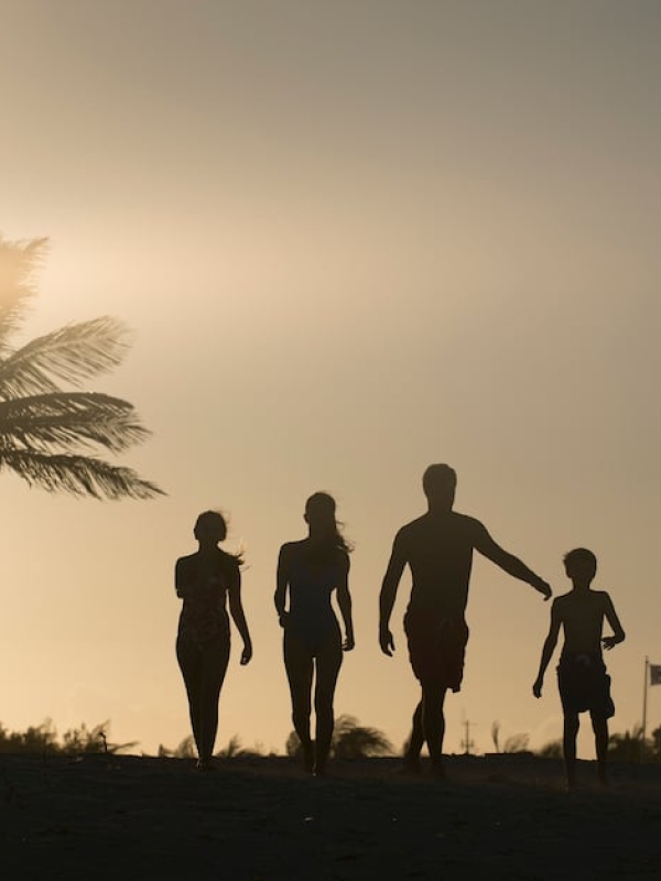 Silhouette of a family of four walking towards the Beach Towers at Atlantis, Paradise Island