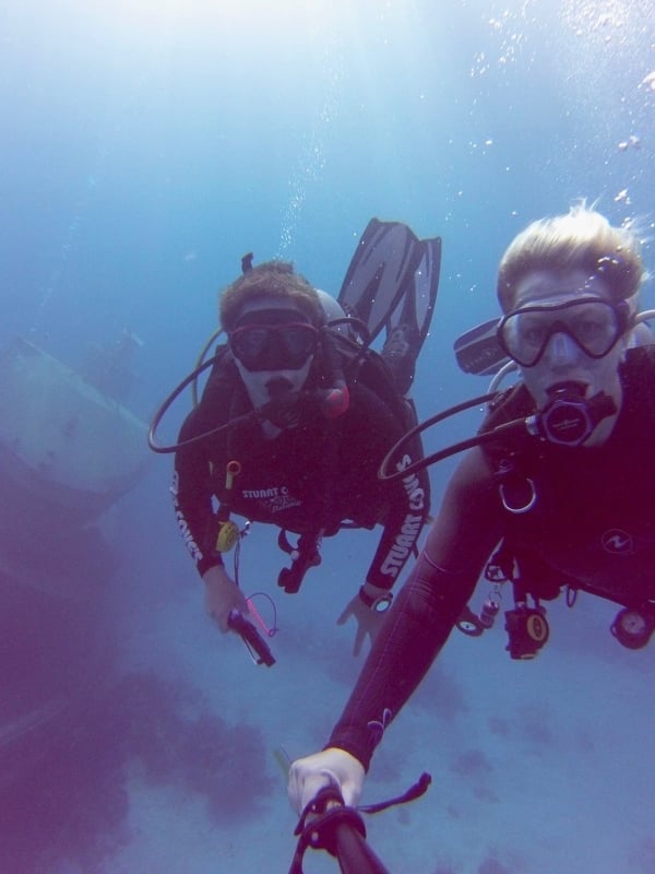 Two scuba divers explore a wreck in The Bahamas