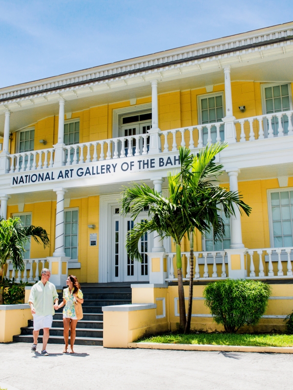 A man and woman exit the National Art Gallery of The Bahamas