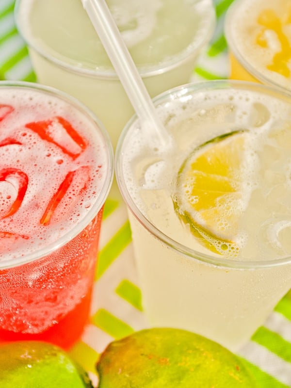 Colorful tropical drinks and sliced limes