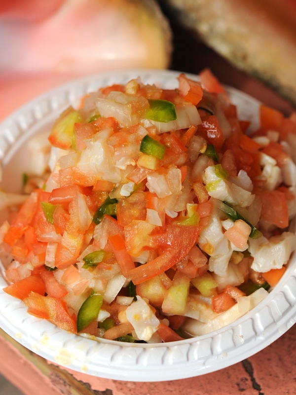 A close-up photo of a bowl of fresh conch salad. 