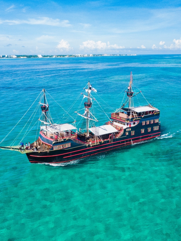 A pirate ship in the middle of turquoise waters