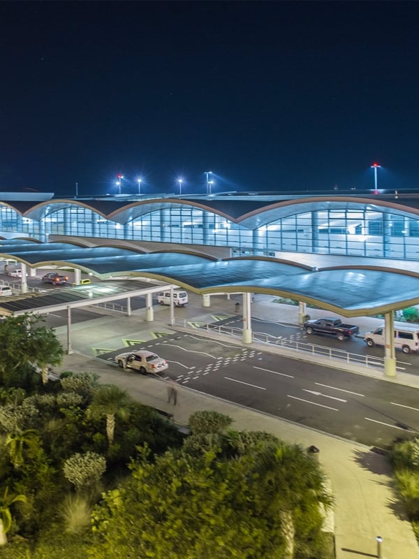 A lit up airport at night.