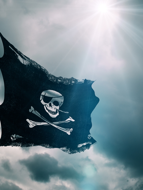 The Jolly Roger Pirate Flag flaps in the breeze. 