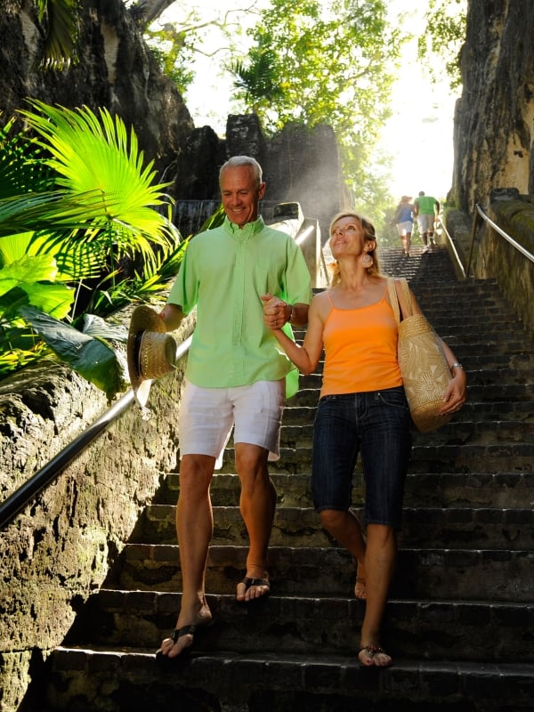 Couple walking down a sunlit staircase