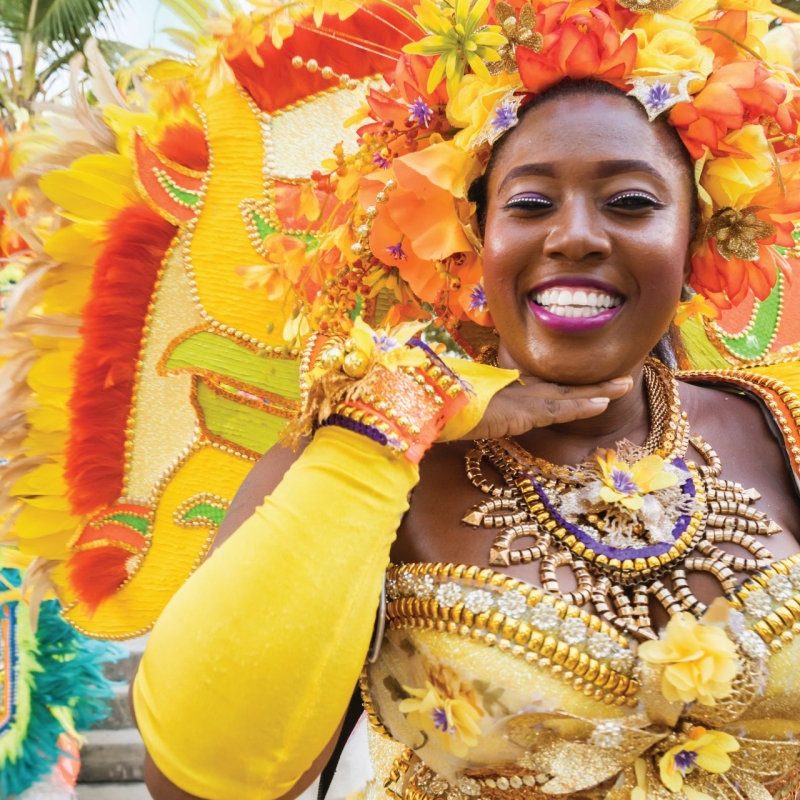 lady dressed in yellow traditional junkanoo attire