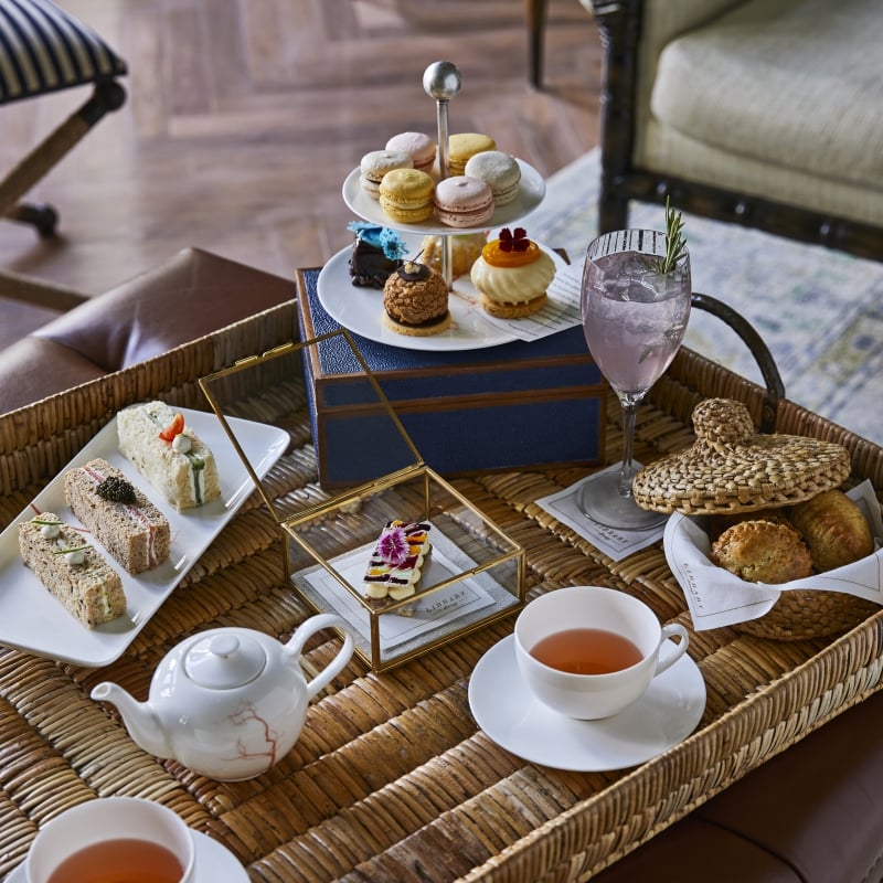 afternoon tea set up on a wicker table